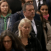 Jason Kenney, working remotely by cellphone from London queue, tweets ostentatiously while waiting to bid farewell to Queen