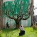 A new Banksy mural sprouts beside a cropped tree in London. Many see an environmental message